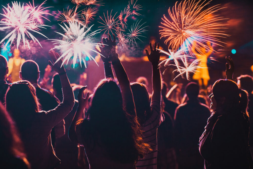Cheering crowd watching fireworks. (c) AdobeStock
