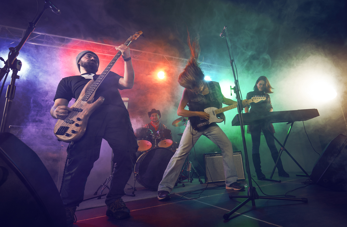 Fulminante Re-Launch-Party lässt Herzen und Seismographen höher schlagen 23 Rock band performs on stage. Guitarist, bass guitar and drums. Scene, light. (c) AdobeStock