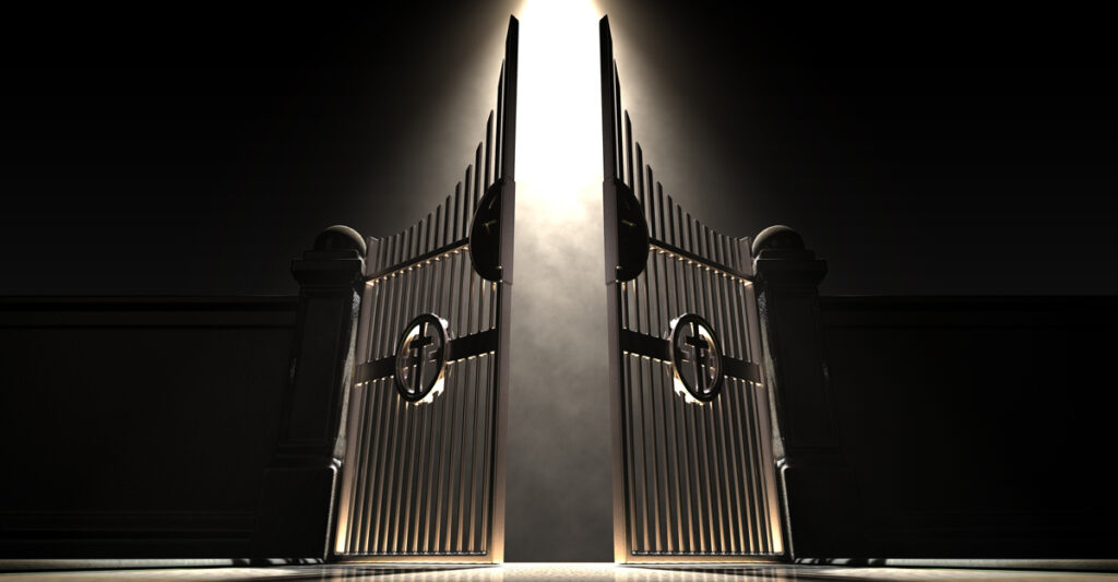 The pearly gates of heaven spotlit from above by an ethereal light on a dark moody background. (c) AdobeStock