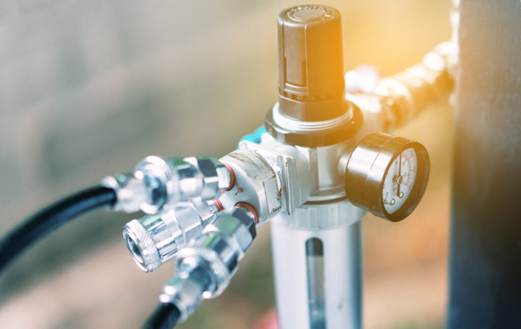 Closeup of a pressure meter on a machine, for checking air pressure and filling air in the tires with Car eletric pump. (c) AdobeStock